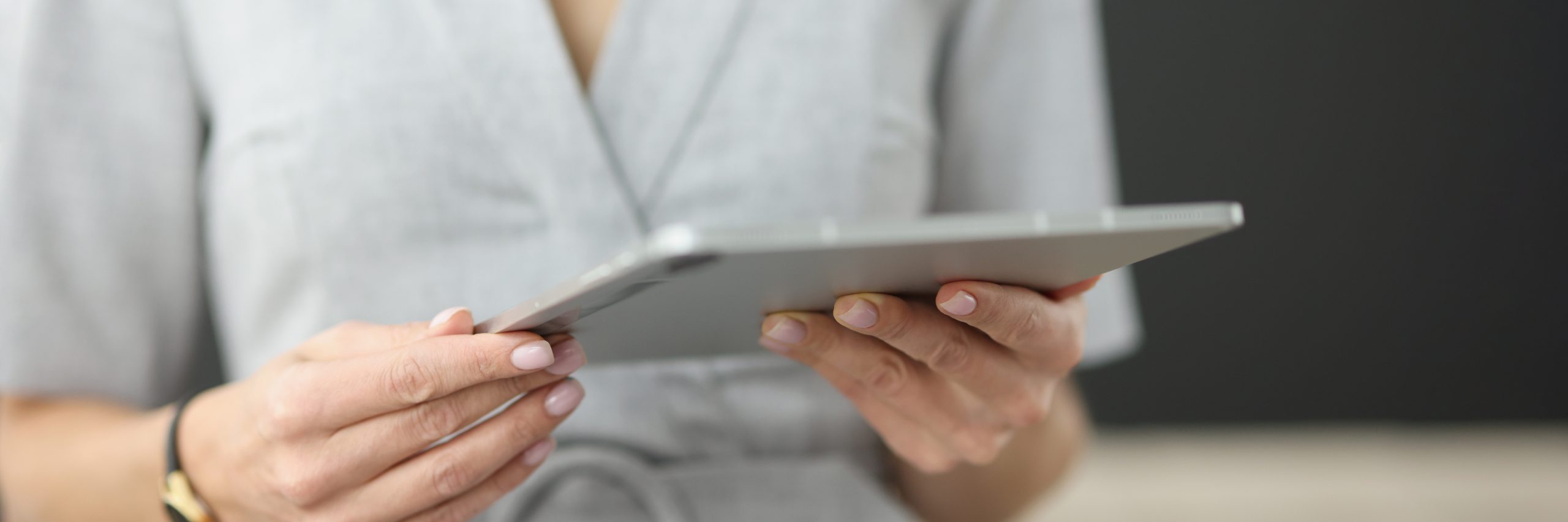 businessman is holding modern tablet in hands while studying new application development of scaled