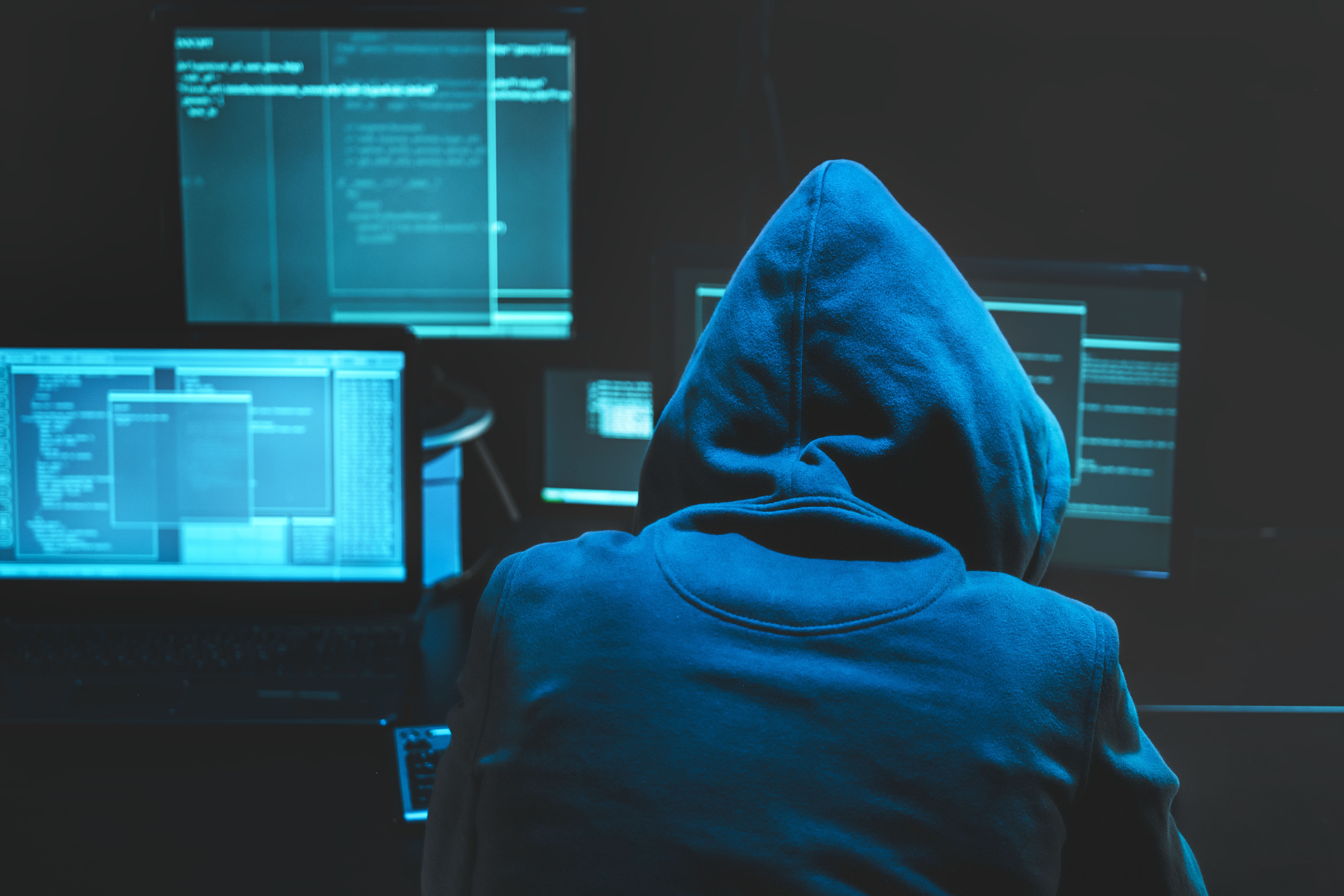 hacker using computer for organizing massive data breach attack on goverment servers hacker in dark 2 1
