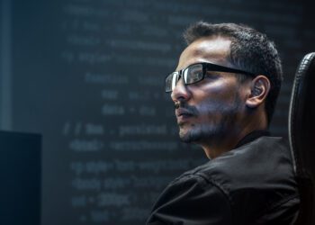 Man analysing binary code on virtual screen
