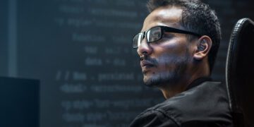 Man analysing binary code on virtual screen